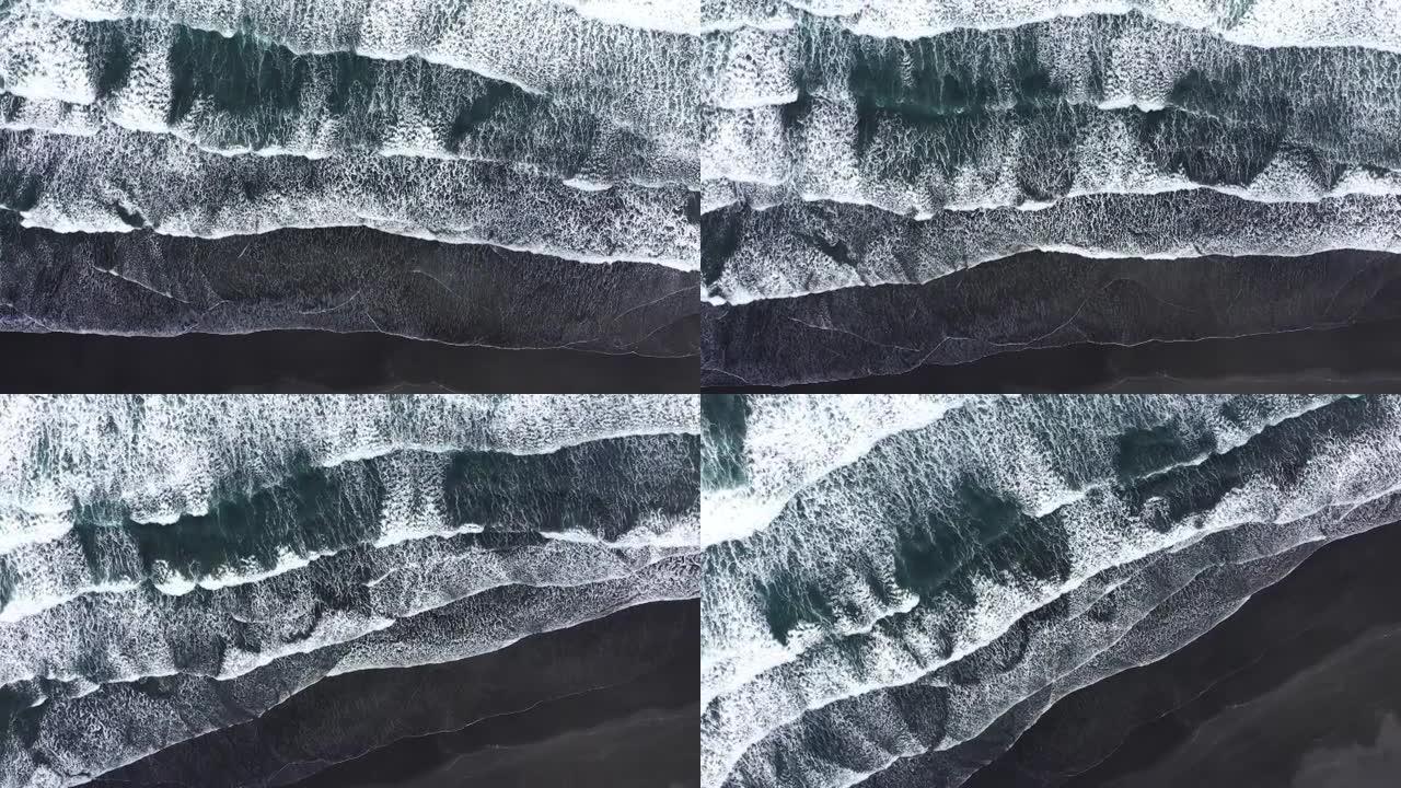 大西洋海浪冲刷冰岛火山黑沙滩海岸线的鸟瞰图