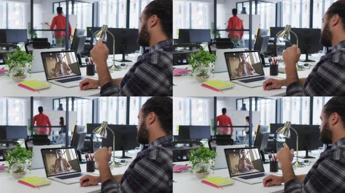 中东男子在办公室的笔记本电脑上与男同事进行视频通话