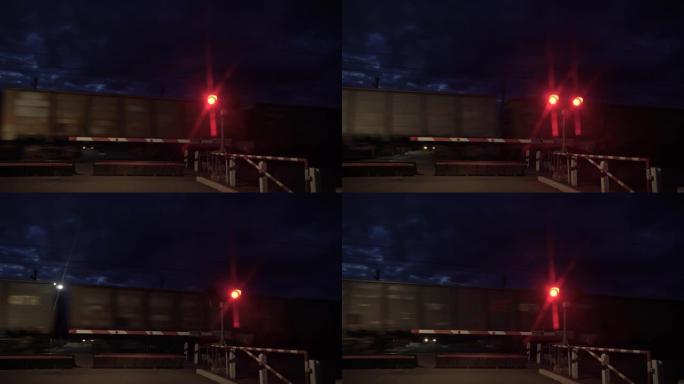 铁路交通信号灯为红色。在铁路道口停车的停车信号。火车在铁轨上高速运动。禁止交通灯信号