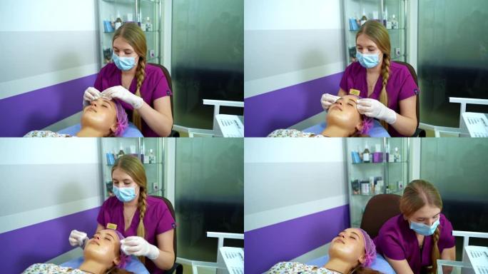 美容师在用餐巾纸进行整容手术之前会清洁女人的脸。顶部的视频。