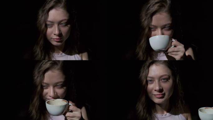 女孩从白杯中愉快地喝咖啡的特写镜头