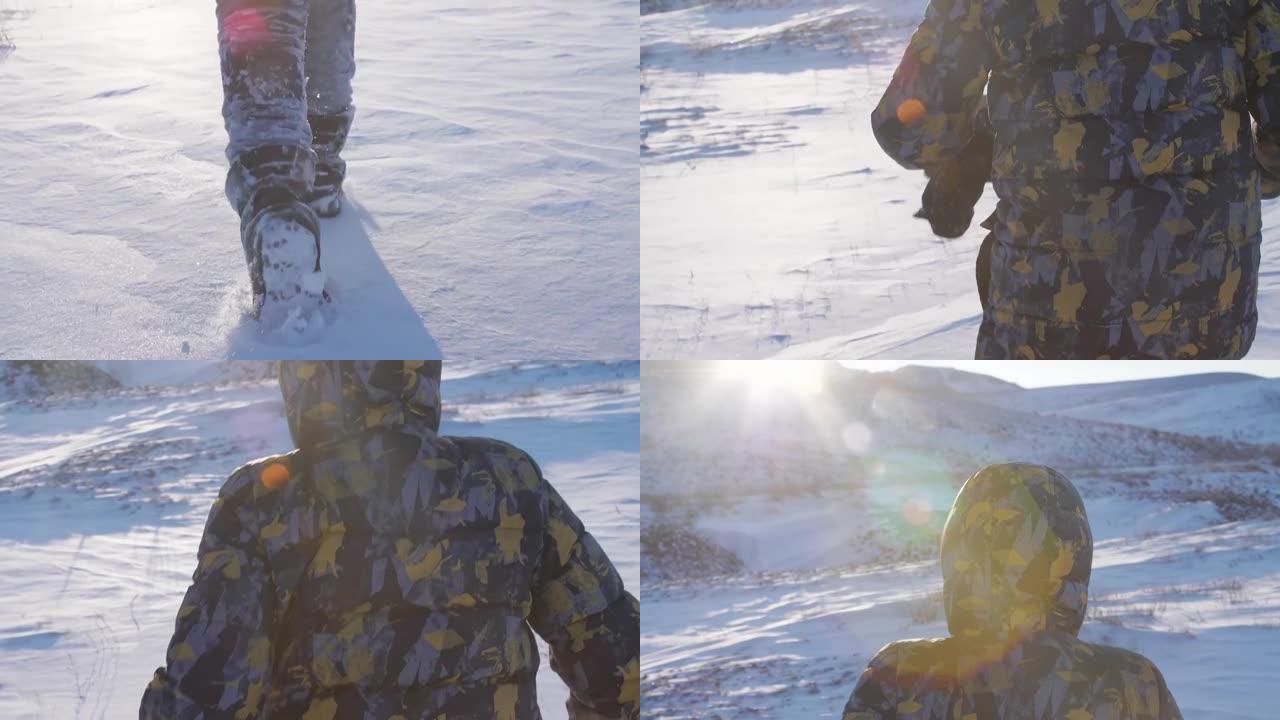 孩子的脚在明亮的霜冻的阳光下闪闪发光的白雪上奔跑。男孩朝着夕阳奔向太阳的光芒