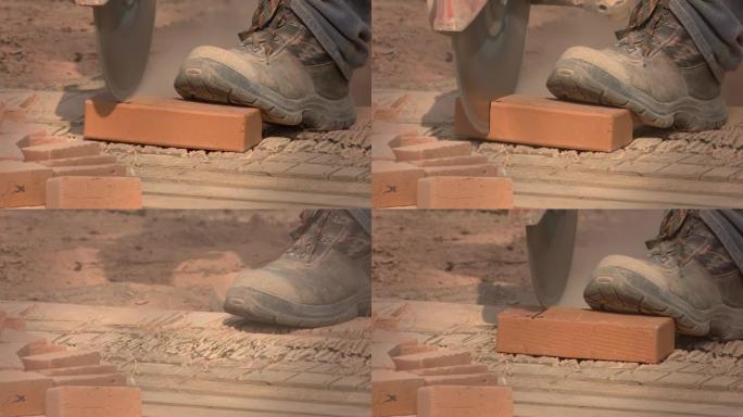 铺设铺路板一名工人用电锯将脚切成所需的尺寸，将瓷砖压在地板上。