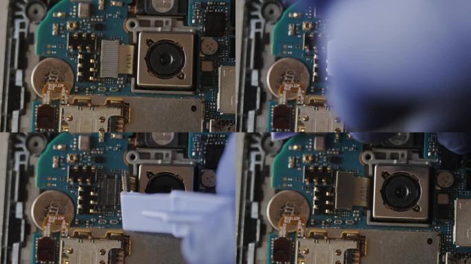 电子维修服务中修理工的特写镜头借助特殊工具拆卸手机进行维修或诊断，