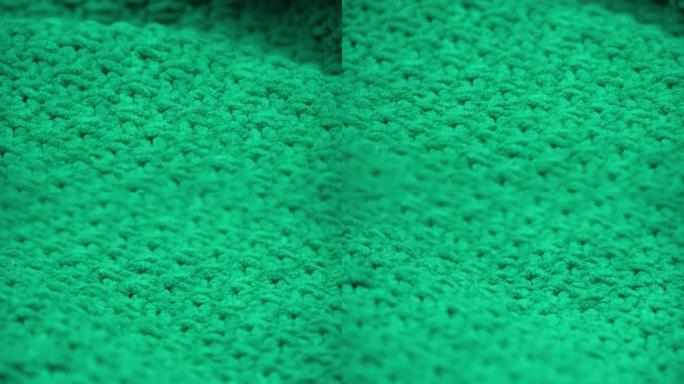 超级特写。绿色针织羊毛面料的细节。纺织背景。宏