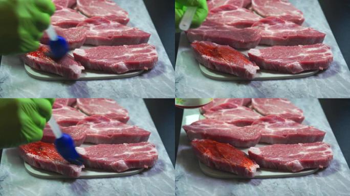 用烧烤腌泡汁刷牛排的特写镜头。食品与健康概念。