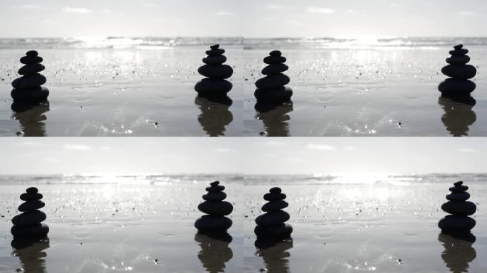 海洋海滩上的岩石平衡，海水波浪堆积的石头。沙滩上的鹅卵石金字塔