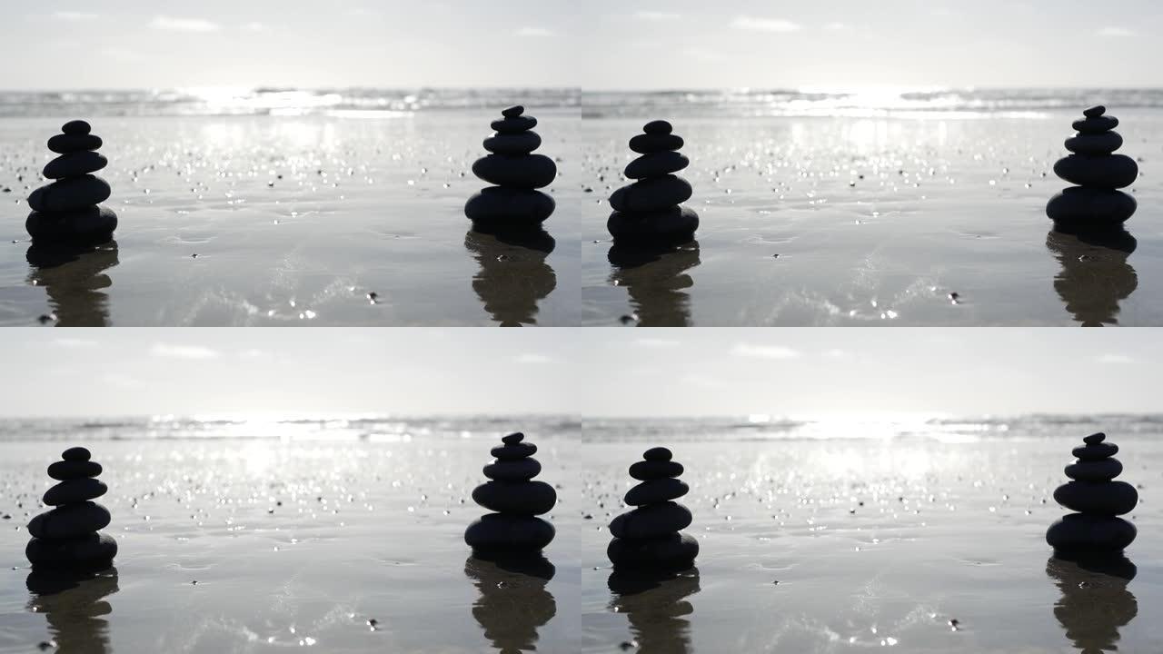 海洋海滩上的岩石平衡，海水波浪堆积的石头。沙滩上的鹅卵石金字塔