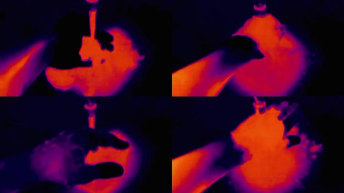 男性在水中洗手的热成像视图。红外、热成像、夜视成像