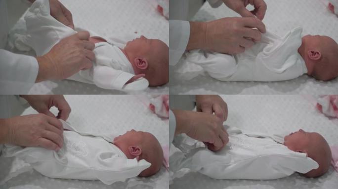 甜美的新生女婴在妇产医院穿着蹒跚。婴儿新生婴儿脸肖像。产妇健康儿童概念。为人父母。做母亲。美丽幸福的