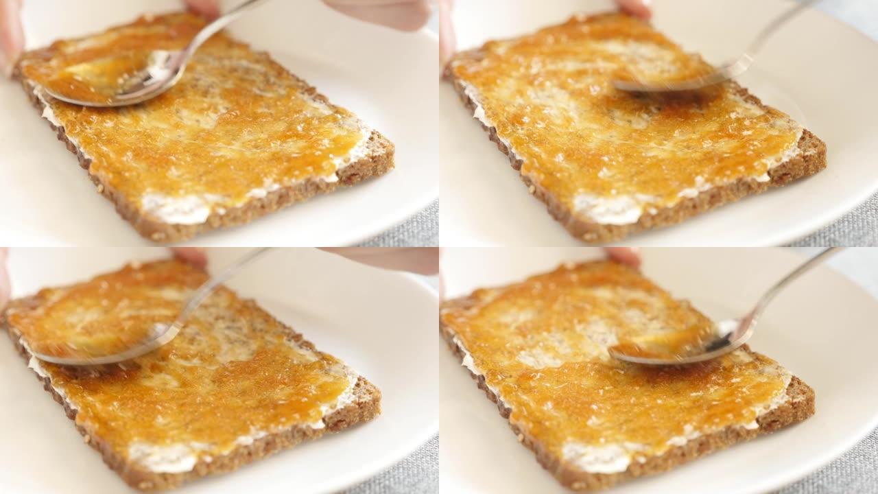 早餐准备用黄油和果酱铺在面包上4k视频