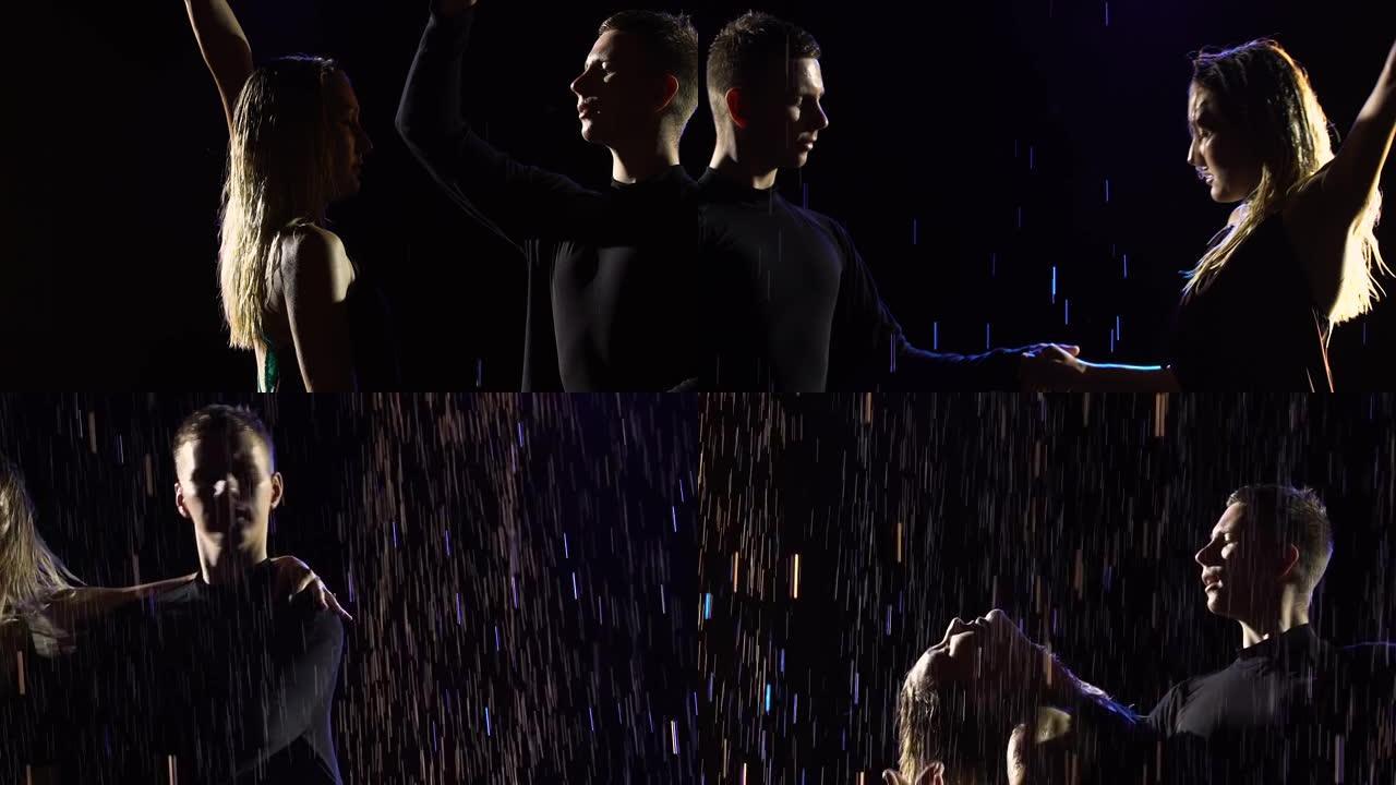 一对舞厅舞者的剪影，在黑色工作室背景上表演拉丁舞bachata的元素。一个男人和一个女人在雨中跳舞。