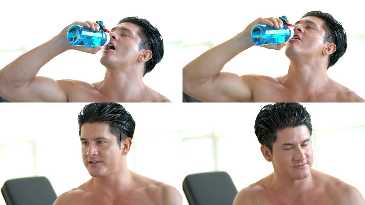 肌肉男从塑料瓶喝水的肖像。健康生活方式的活动。