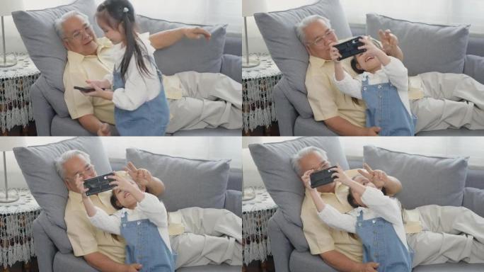 祖父和孙子用智能手机拍照