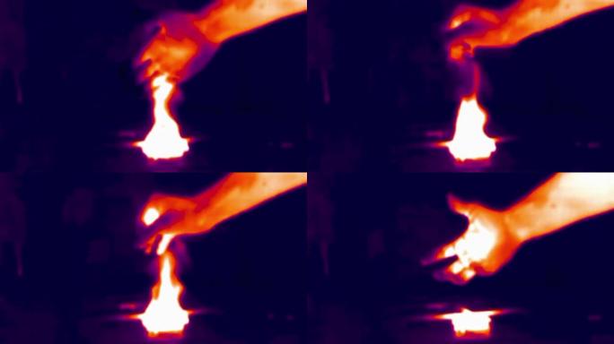 火中的手的热成像视图。红外、热成像、夜视成像