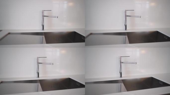 厨房水槽和水龙头。简单精心设计的现代厨房内部