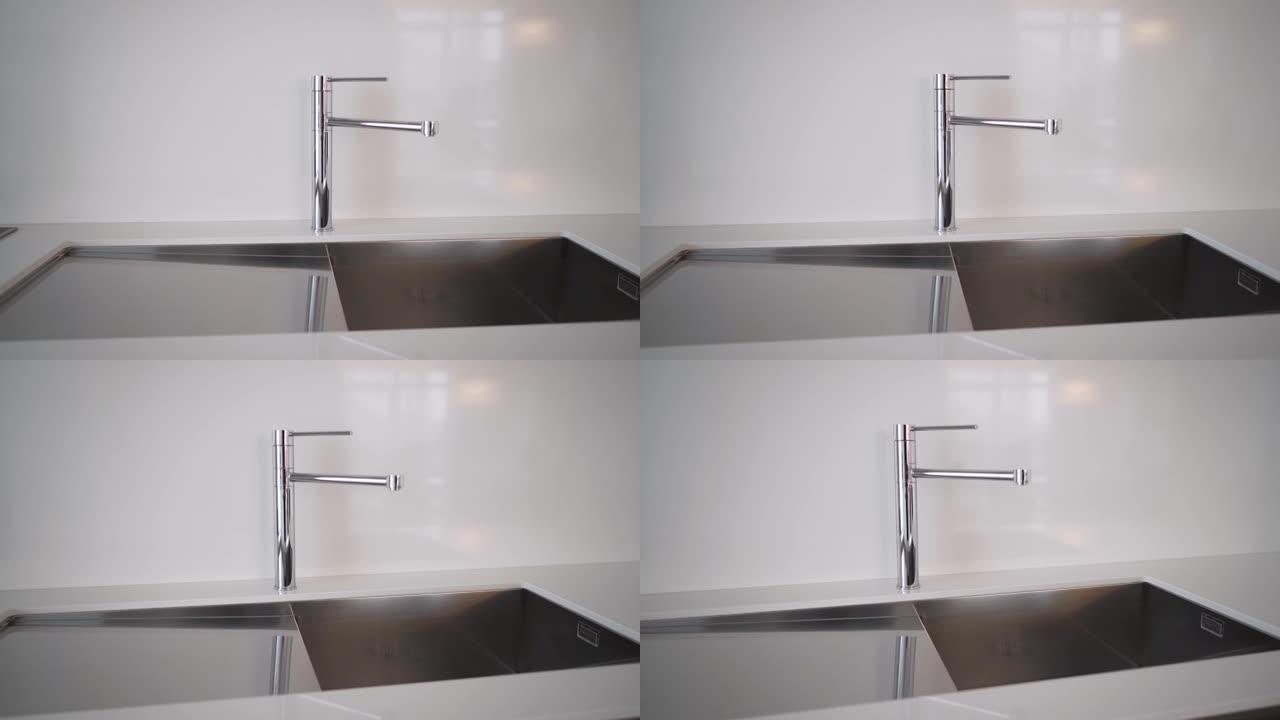 厨房水槽和水龙头。简单精心设计的现代厨房内部