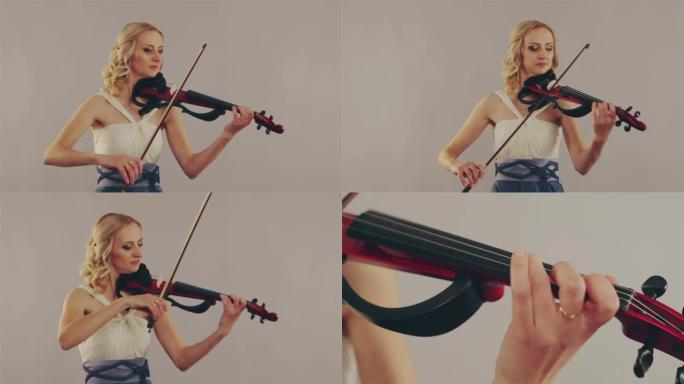 年轻女子在灰色背景上拉小提琴