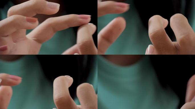 快乐的亚洲女孩在家用指甲油画她的手指，生活方式的概念。