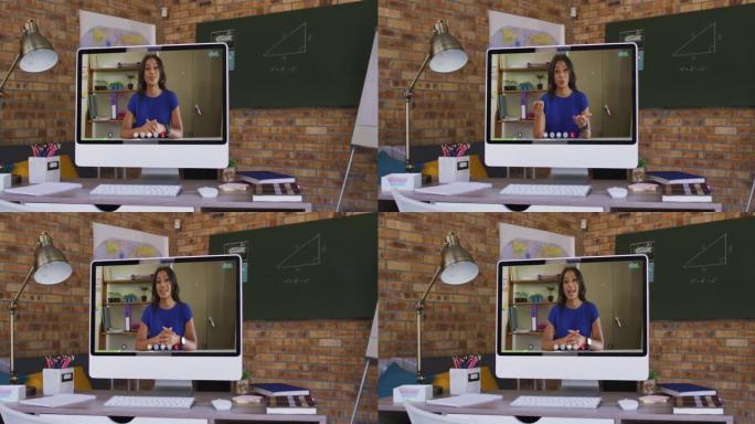 混合种族妇女在办公桌上的计算机屏幕上进行商务视频通话