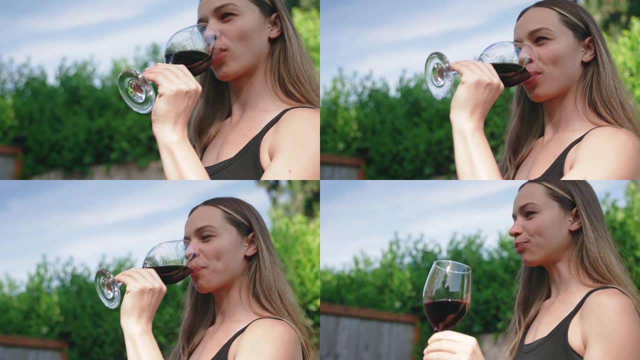 女人在户外享受一杯葡萄酒
