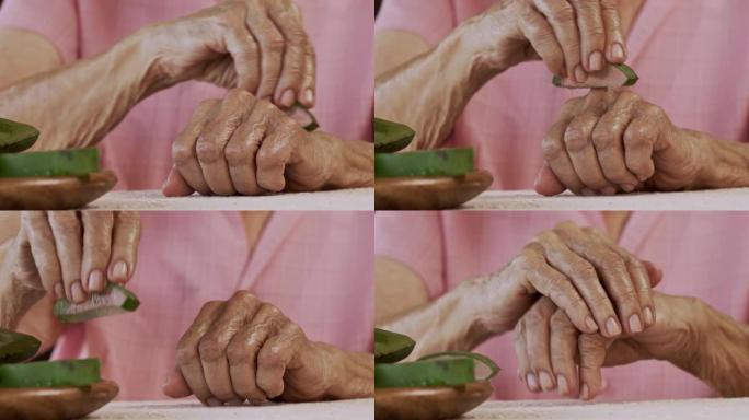 西班牙裔高级女性慢动作特写，用芦荟保湿乳液搓手，作为皮肤保护的常规