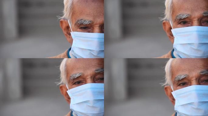 戴着医用口罩保护自己免受电晕病毒大流行的印度老人的半脸肖像。有复制空间