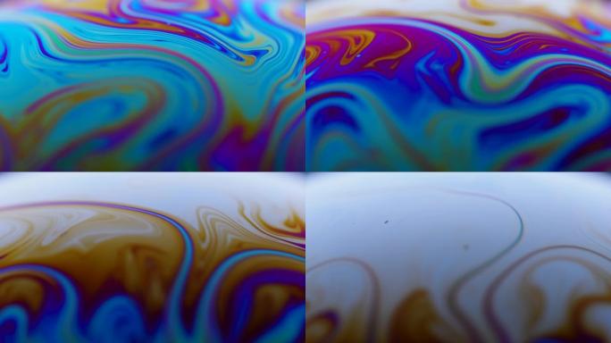 彩虹颜色变化的液体肥皂的表面。光在肥皂泡上折射，vacro关闭移动的颗粒。特写。慢动作