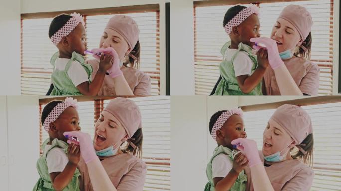 一名年轻牙医刷牙可爱的小女孩牙齿的4k视频片段