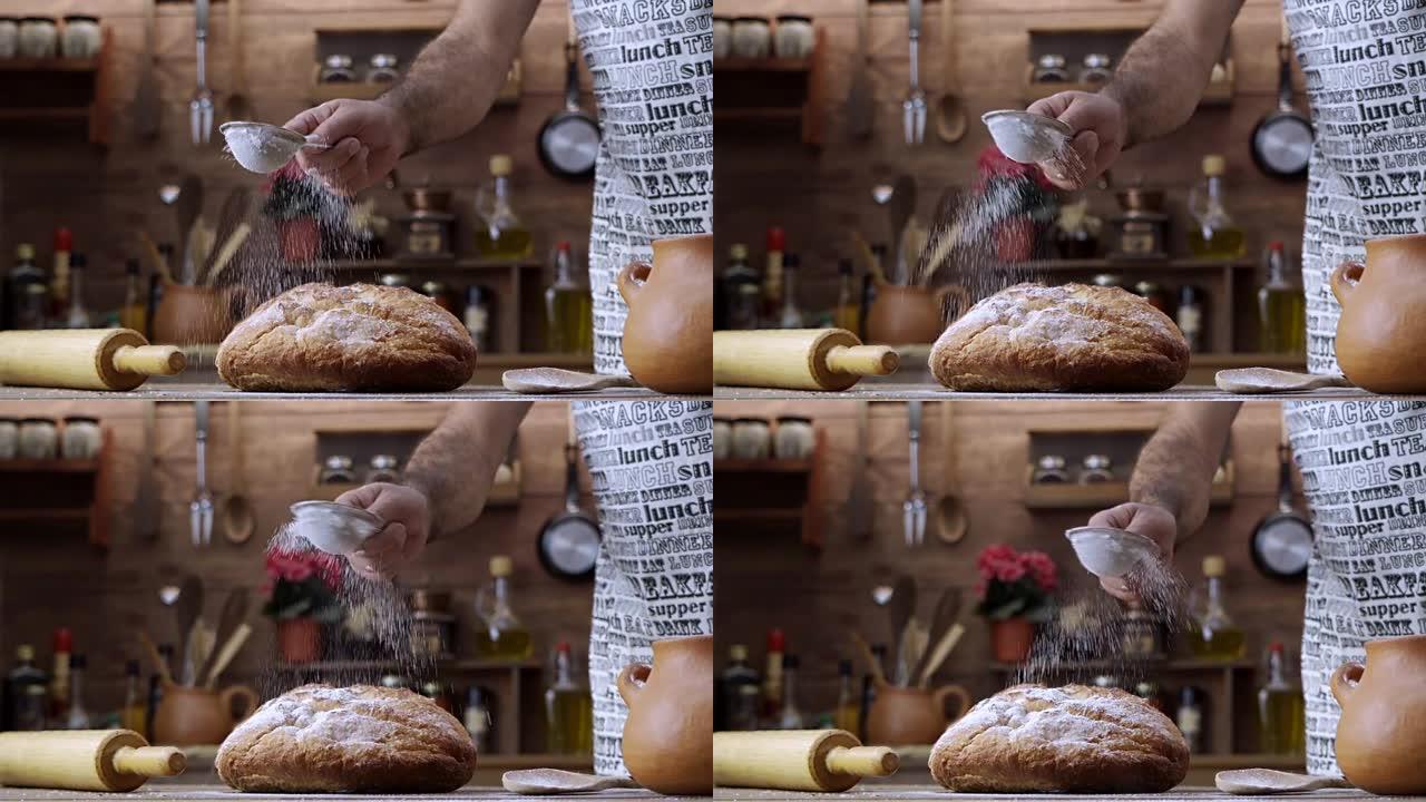 人的慢动作手在新鲜出炉的甜圆面包上倒糖粉