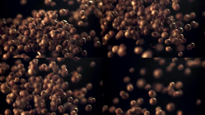 胡椒粒的超慢动作被扔在黑色背景下。以1000 fps的速度在相机上拍摄。