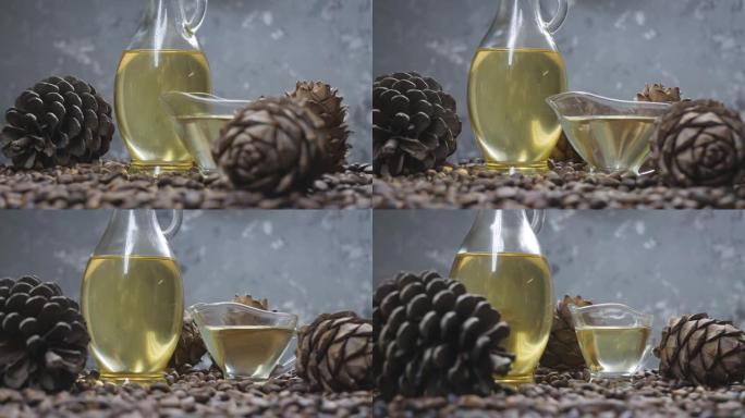 雪松坚果油在玻璃瓶和黄油盘中旋转。雪松种子，雪松球果一起旋转。生产用于食品和化妆品的雪松坚果油