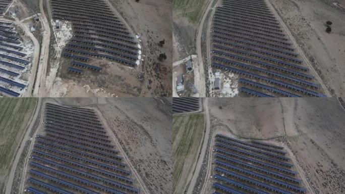 在山上贫瘠的土地上，用无人机飞越太阳能电池板。