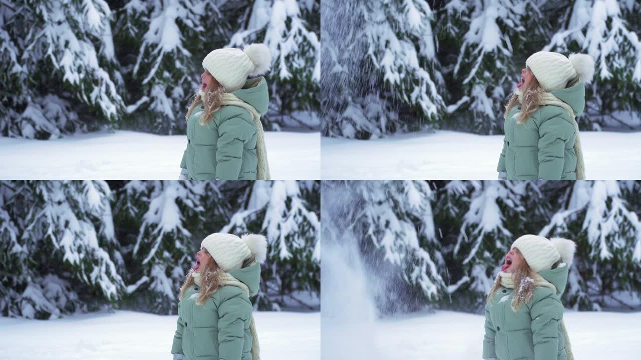 快乐的小女孩在雪地里玩耍。森林里下雪寒冷的冬天。圣诞节前雪花飘落。用舌头捕捉飘落的雪。快乐的童年和大