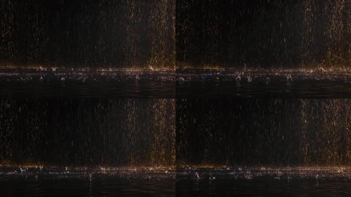 雨滴落在水的发光表面上。飞溅的水在黑色工作室背景下向不同方向散射。雨水从上面倾泻而下。特写。慢动作