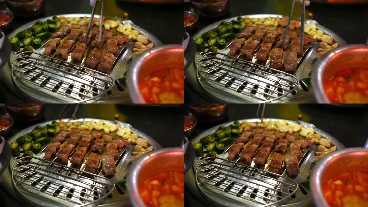 4k厨师手工烹饪韩式烧烤猪肚配大蒜青椒炭炉