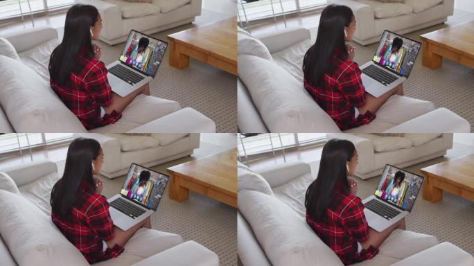 非裔美国妇女坐在家里的沙发上在笔记本电脑上进行视频通话