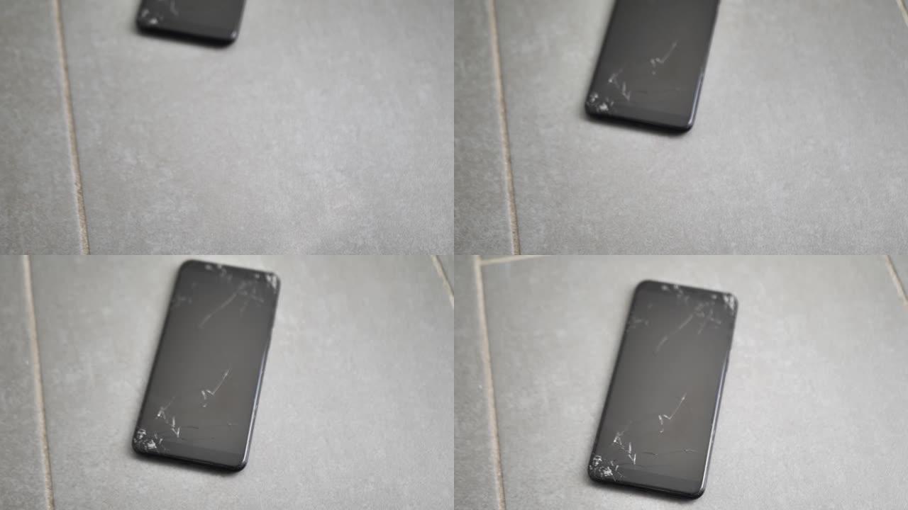 地上是一部屏幕坏了的手机