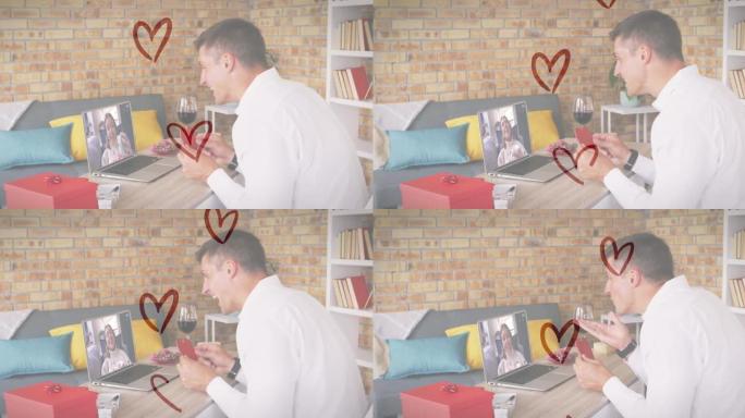 高加索人的心脏图标拿着心形标语牌，同时在笔记本电脑上进行视频通话