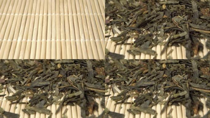 干草本青麻茶叶。慢动作落在竹席上