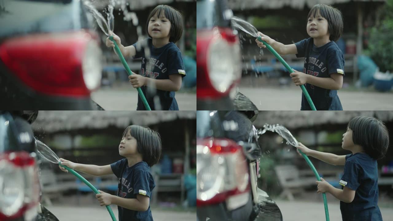 亚洲小女孩喜欢在前院洗车。