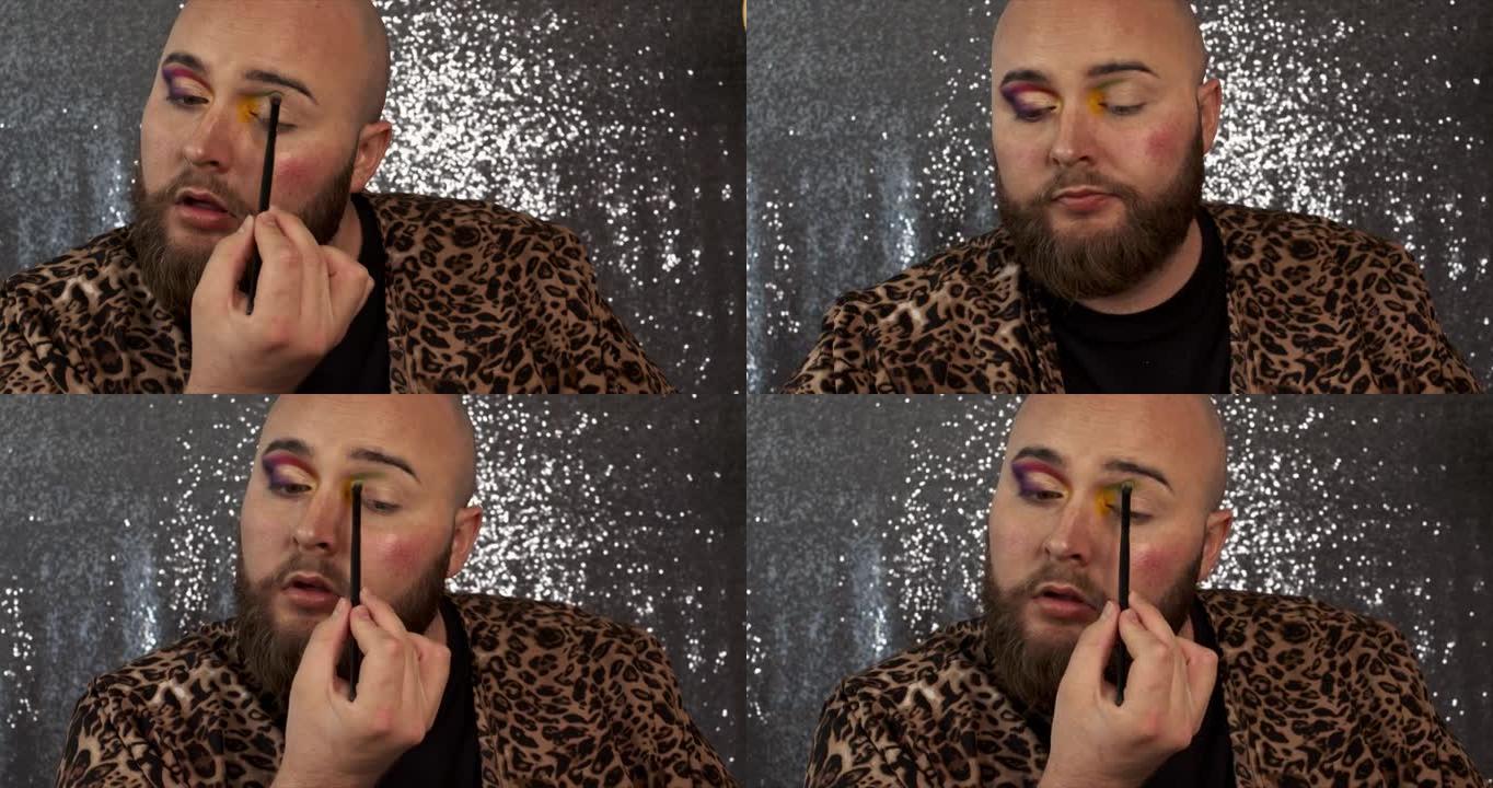 一位男性化妆师在折痕上涂上橄榄绿色眼影的4k视频片段