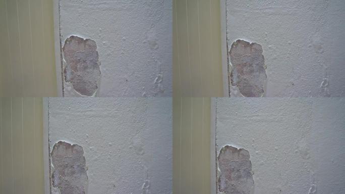 破裂的油漆屋墙的多莉滑块。破坏了墙上的白色油漆。旧风化墙老房子的垃圾质地。抽象白色和灰色水泥墙背景或