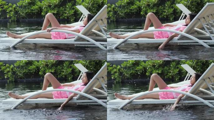 快乐的亚洲人在酒店度假期间在泳池床上放松，生活方式理念。