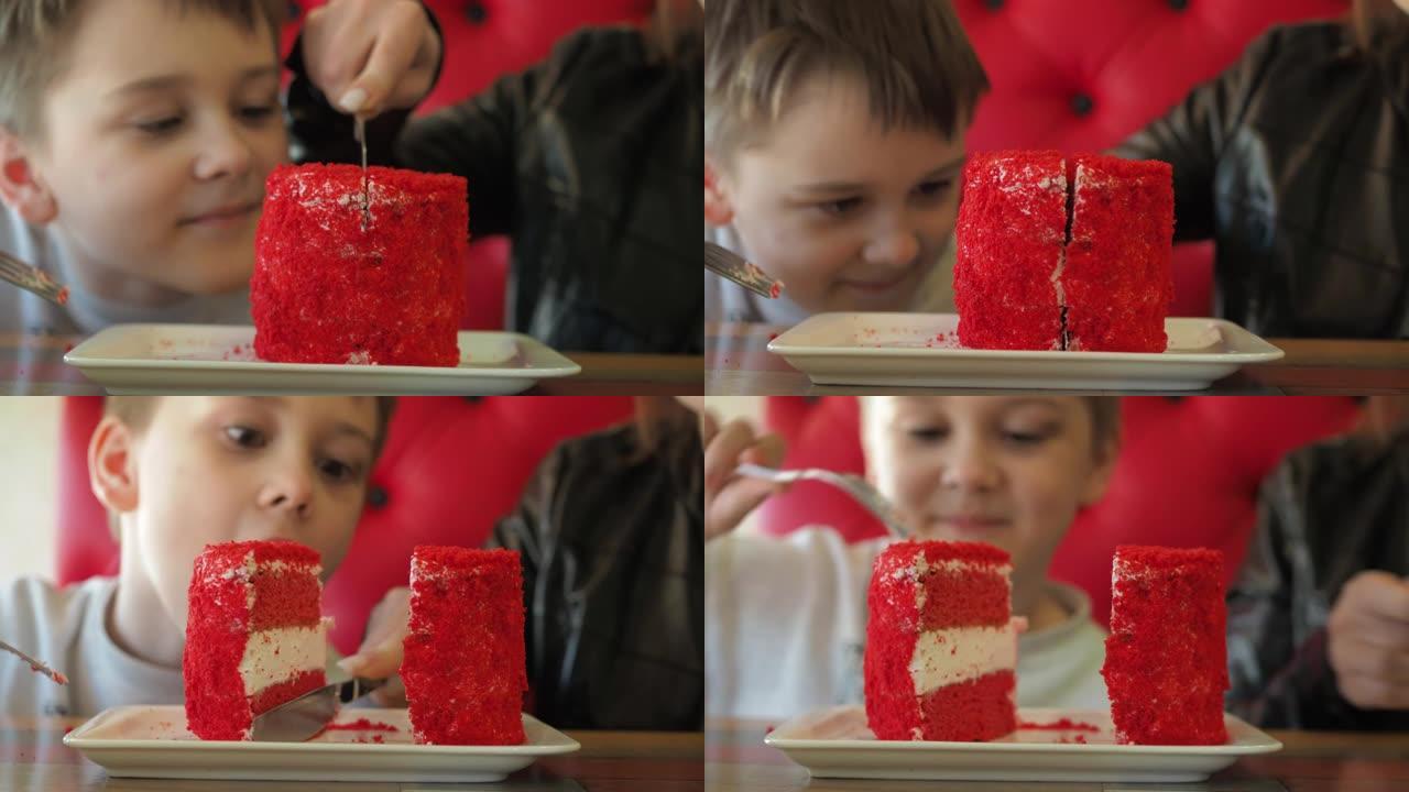 这个男孩被切成盘子里的蛋糕。红色海绵蛋糕聚焦，男孩注意力不集中。惊喜的情绪，孩子脸上的幸福