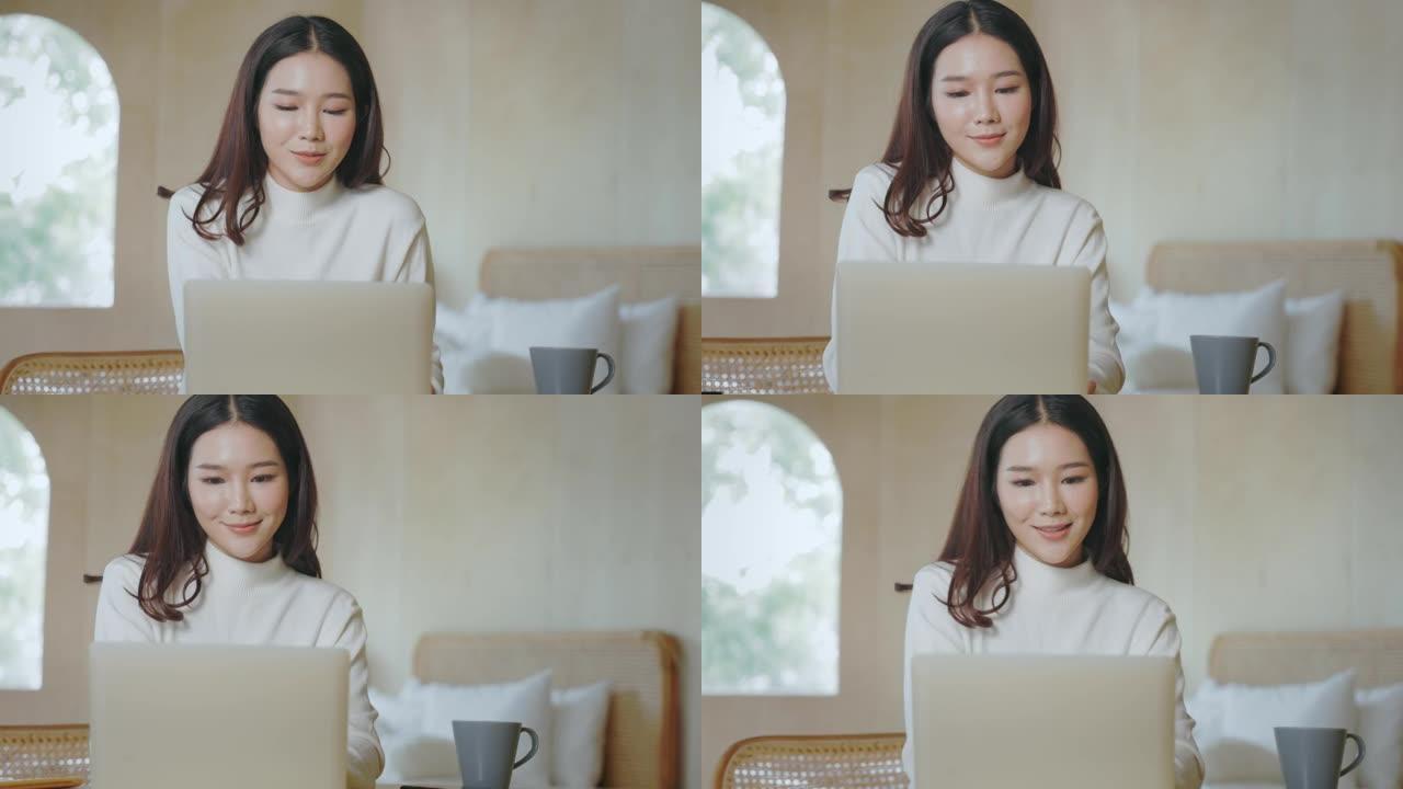 慢动作图像特写的好看，漂亮的脸蛋，迷人的亚洲女性，可爱。她使用笔记本电脑查看在线内容。青年学生在家上