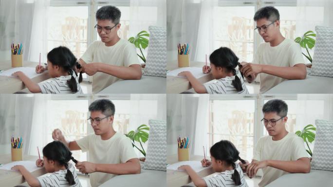 亚洲女孩在做作业，父亲在客厅里梳头编织头发。
