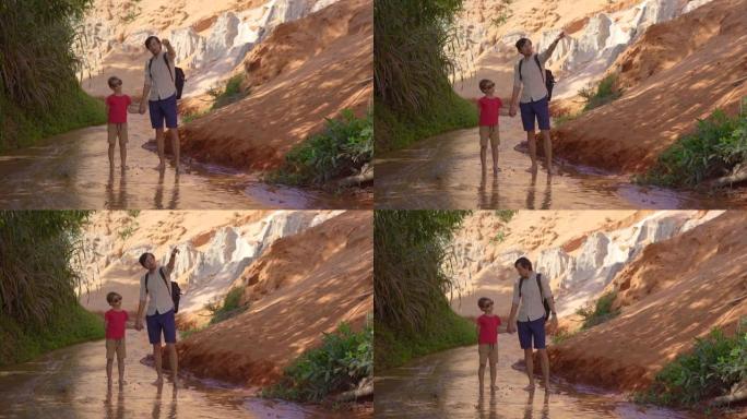 一家人沿着越南南部美内村沙漠边界的红色峡谷或仙女溪漫步