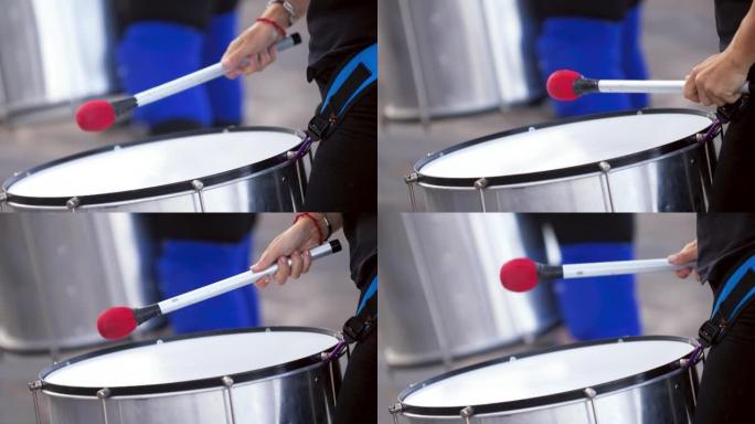 特写4k视频，街头音乐家用棍子在大鼓上演奏。文化节或城市街道表演