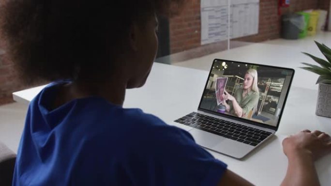 非裔美国妇女在办公室的笔记本电脑上与女同事进行视频通话